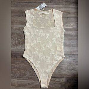 Chic Cream Mesh Bodysuit with Bow Design